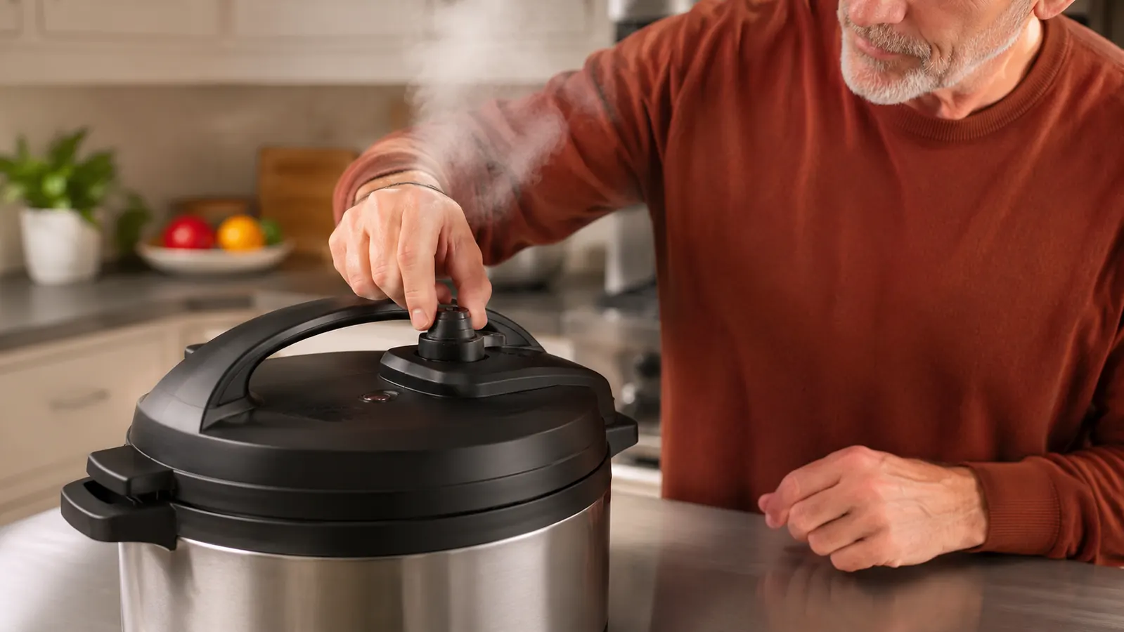 Hand setting the steam release valve on an electric pressure cooker while steam puffs from the vent